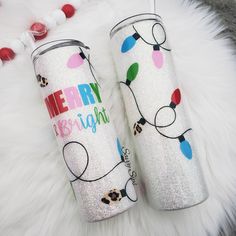 two personalized tumbles with christmas lights on them