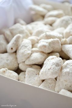 a white bowl filled with marshmallows on top of a table