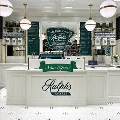 the interior of a coffee shop with green and white signs on the wall above the counter