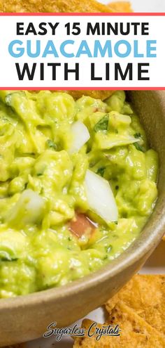 guacamole with lime in a bowl and tortilla chips on the side