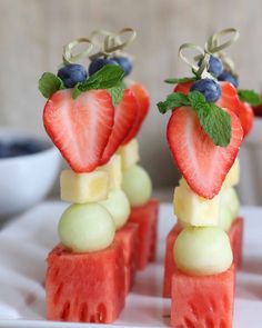 two pieces of watermelon with fruit on them