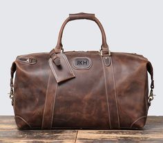 "Personalized Leather Duffel Bag, Overnight Bag, Weekend Bag, Carry on Bag, Groomsmen Gift Duffle Bag, Father's Gift, Gift for Him Personalization: We can engrave initials on the front. Please leave a note at checkout with what you would like personalized on. Features: 1. This overnight bag is mainly made of full grain cowhide leather.  Suitable for weekend trips, short-term business trips, and daily trips, and with enough space for travel necessities. 2.Adjustable Shoulder Strap, Metal Studs un Rectangular Bags With Smooth Grain For Overnight Trips, Rectangular Bag With Smooth Grain For Overnight Trips, Rectangular Smooth Grain Bag For Overnight Trips, Leather Overnight Bag, Leather Duffel Bag, Travel Necessities, Leather Duffel, Engraved Initials, Men Gifts