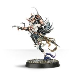 a figurine is standing on a white surface with an evil face and horns