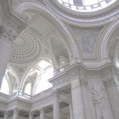 the interior of a building with columns, arches and ceiling murals on it's walls