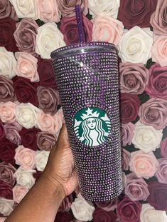 the starbucks cup has been decorated with swarong and is being held up by someone's hand