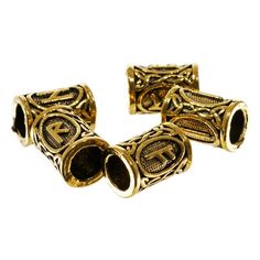 two gold tone metal beads with decorative designs