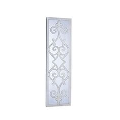 a white wall hanging with an intricate design on the front and back of it's frame