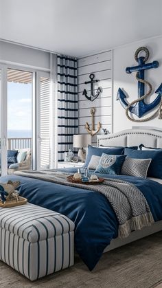 a bedroom with an anchor on the wall and blue bedding in front of a large window