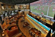 an overhead view of a sports bar with large televisions