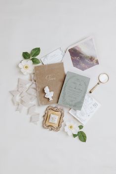 the wedding stationery is laid out on top of each other with flowers and photos