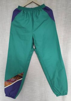 Artsy looking sport pants with lining. Great condition, 2 secure side pockets. Asymmetric design. Pants made of windproof material. Measurements; length-104cm, waist- up to 86 cm in circumference. Size M. Sporty Green Pants With Elastic Side Panels, Green Sportswear Pants With Pockets, Green Joggers With Side Pockets For Outdoor, Green Outdoor Joggers With Side Pockets, Green Stretch Parachute Pants For Outdoor, Sporty Green Pants For Outdoor Activities, Green Sporty Pants For Outdoor Activities, Green Outdoor Pants With Elastic Waistband, Sporty Green Parachute Pants For Outdoor Activities