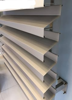 a close up view of some shelves in a room with white walls and tile flooring