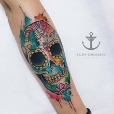 a colorful skull tattoo on the arm