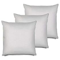 three white pillows sitting next to each other