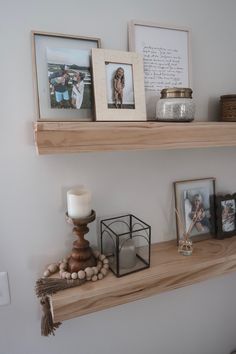 two shelves with pictures and candles on them