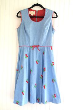 "This is a darling novelty, cherry theme embroidered dress.  It has never been worn and is in very good to excellent vintage conditon. Marked vintage size 14 Estimated size 12 38\" bust 32\" waist full hip 16\" shoulder to waist 40\" shoulder to hem  Purveyor's Note: We have searched far and wide, wrestled bears, braved the cold, traversed mountain ranges, fought pirates, swam with sharks and eaten at many a questionable road side taco stand to provide our customers with one of a kind vintage pieces.  Know that whichever piece you choose to make your own has its own story and has traveled through time to get to you.  Though we strive to provide the absolute best, \"pristine\" vintage pieces are rare birds, if not altogether non-existent.  That being said, please understand that part of buy Vintage Cherry Print Dresses For Spring, Retro Sleeveless Cherry Print Dresses, Retro Fitted Cherry Print Dresses, Cute Fitted Cherry Print Dress, Retro Embroidered Cotton Dress, Retro Embroidered Summer Dress, Summer Retro Embroidered Dress, Fitted Cotton Dress With Cherry Print, Cute Fitted Cotton Vintage Dress