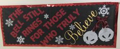 a bulletin board with two bells and snowflakes