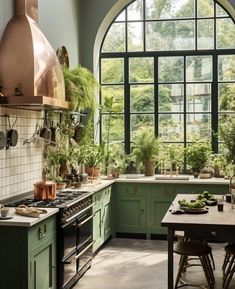 a kitchen with green cabinets and an arched window