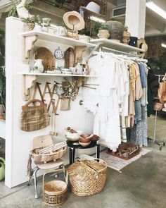 a room filled with lots of clothes and baskets on top of shelves next to each other