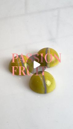 three yellow and white marbles sitting on top of a white surface with the words passion fruit