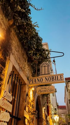 a street sign hanging from the side of a building