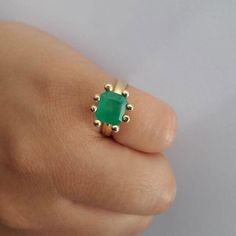 Emerald Ring with dots. Materials:18k Yellow Gold Emerald: 8x4 mmWidth: 8 mm. Each ring is custom made. It takes 20 days to make and ship. We will keep you updated via email. Available in sizes: 4,4 1/2, 5, 5 1/2, 6, 6 1/2, 7, 7 1/2, 8. Each emerald is unique. Elegant Handmade 14k Gold Emerald Ring, Handmade 14k Gold Emerald Ring For Anniversary, Handmade Classic Emerald Rings, Modern Handmade 14k Gold Rings, Handmade 14k Gold Rings For May Birthstone, Classic Handmade Emerald Promise Ring, Handmade 14k Gold Emerald Promise Ring, Handmade Classic Emerald Promise Ring, Handmade 14k Gold Emerald Ring For Promise