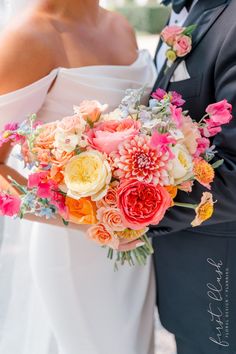 the bride and groom are holding their bouquets