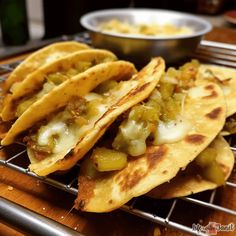 three tortillas with peppers and cheese on a cooling rack