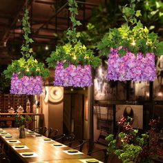 purple flowers hanging from the ceiling in a restaurant