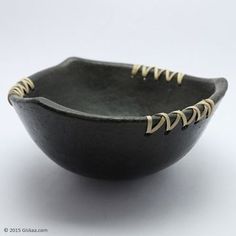 a black bowl with gold trimmings on it