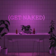 a pink neon sign that reads get naked in front of a table with chairs and potted plants