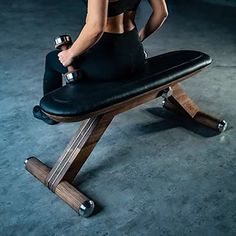 A modern and sleek exercise bench, with a wood and stainless steel core. Does not adjust. Used for dumbbell exercises.47 x 19 x 19"HPrimary image in Natural Walnut wood finish, with black leather. Basic Exercise, Bike Machine, Luxury Fitness, Workout Bench, Medicine Ball Workout, Ash Beige, Spa Ideas, Medicine Balls, Black Ash