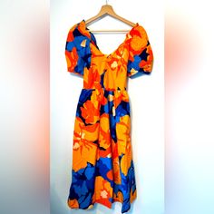 Tabitha Brown Floral Midi Dress. 6. Nwt. Vibrant Floral Beautiful Dress. Knot On The Back. Aline Skirt. Pockets! Vibrant Orange Dress For Brunch, Vibrant Orange Midi Dress For Spring, Vibrant Orange Midi Dress For Beach, Vibrant Blue Midi Dress For Vacation, Vibrant Blue Dress For Brunch, Vibrant Print Orange Midi Dress For Summer, Orange Midi Dress With Vibrant Print For Summer, Orange Cotton Midi Dress For Vacation, Vibrant Orange Midi Dress For Vacation