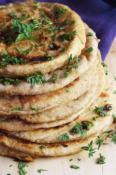 a stack of pita bread with herbs on top