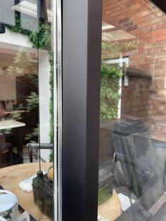 an open window with the reflection of a house in it