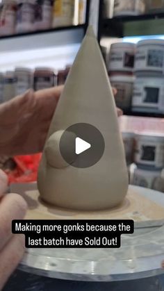 a person is making a vase out of clay