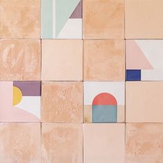 an abstract painting made up of different shapes and colors on the wall, including oranges, pinks, blue, yellows