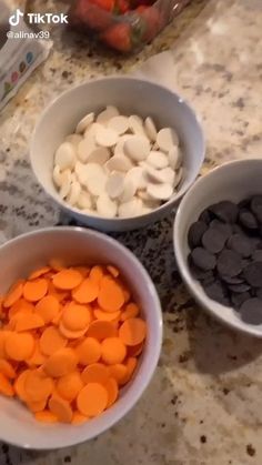 three bowls filled with carrots, black beans and other ingredients on a counter top