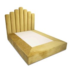 an upholstered bed frame made out of cardboard with rolled ends on the sides