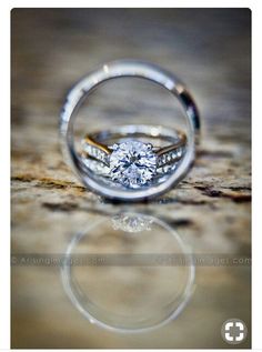 two wedding rings sitting on top of each other