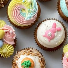 cupcakes decorated with colorful frosting and decorations on top of each other,