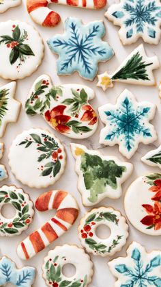 decorated christmas cookies are displayed on a table