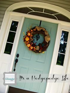 a blue front door with a wreath on it and the words, its a hedgedale life