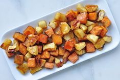 a white plate topped with potatoes on top of a table