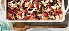 an oatmeal dish with berries, almonds and blueberries in it