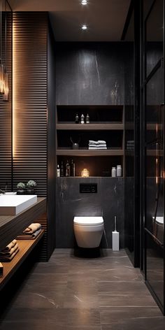 a modern bathroom with black walls and flooring