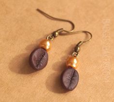 Please check my shop policies and FAQ before placing an order. Thank you :) Earrings for all coffee lovers. Realistic coffee beans handmade of polymer clay, adorned with pearly beads. Length (without the hook): 2cm (0,8'') Hook shape may vary depending on stock availability. The photo represents an item that is already sold - the pair you receive will be very similar but not identical. More coffee jewelry: Coffee cup pendant https://www.etsy.com/listing/129577593/coffee-cup-pendant-custom-toppin Polymer Clay Coffee Bean Stud Earrings, Faux Coffee, Bean Earrings, Coffee Earrings, Earrings Coffee, Coffee Jewelry, Tea Jewelry, Coffee Earring, Coffee Bean Earrings