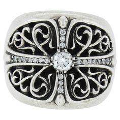 This bold and sharp-looking men's ring by Chrome Hearts is solidly crafted in sterling silver and and features a wide design with detailed scroll open work and is adorned with 0.77 carats of truly fine quality diamonds throughout. The center diamond weighs approximately 0.52 carats and displays incredible amounts of fire and brilliance at the center of this wide ring. Enjoy :) --Stone(s):-- (1) Natural Genuine Diamond - Round Brilliant Cut - Prong Set - 0.52ct (approx.) (20) Natural Genuine Diam Chrome Hearts Ring, Diamond Band Ring, Estate Rings, Wide Ring, Wide Rings, Sterling Silver Mens, Diamond Rings Bands, Men's Ring, Chrome Hearts