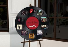 a black record with the rolling stones on it is standing in front of a window