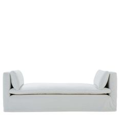 a white couch sitting on top of a white floor